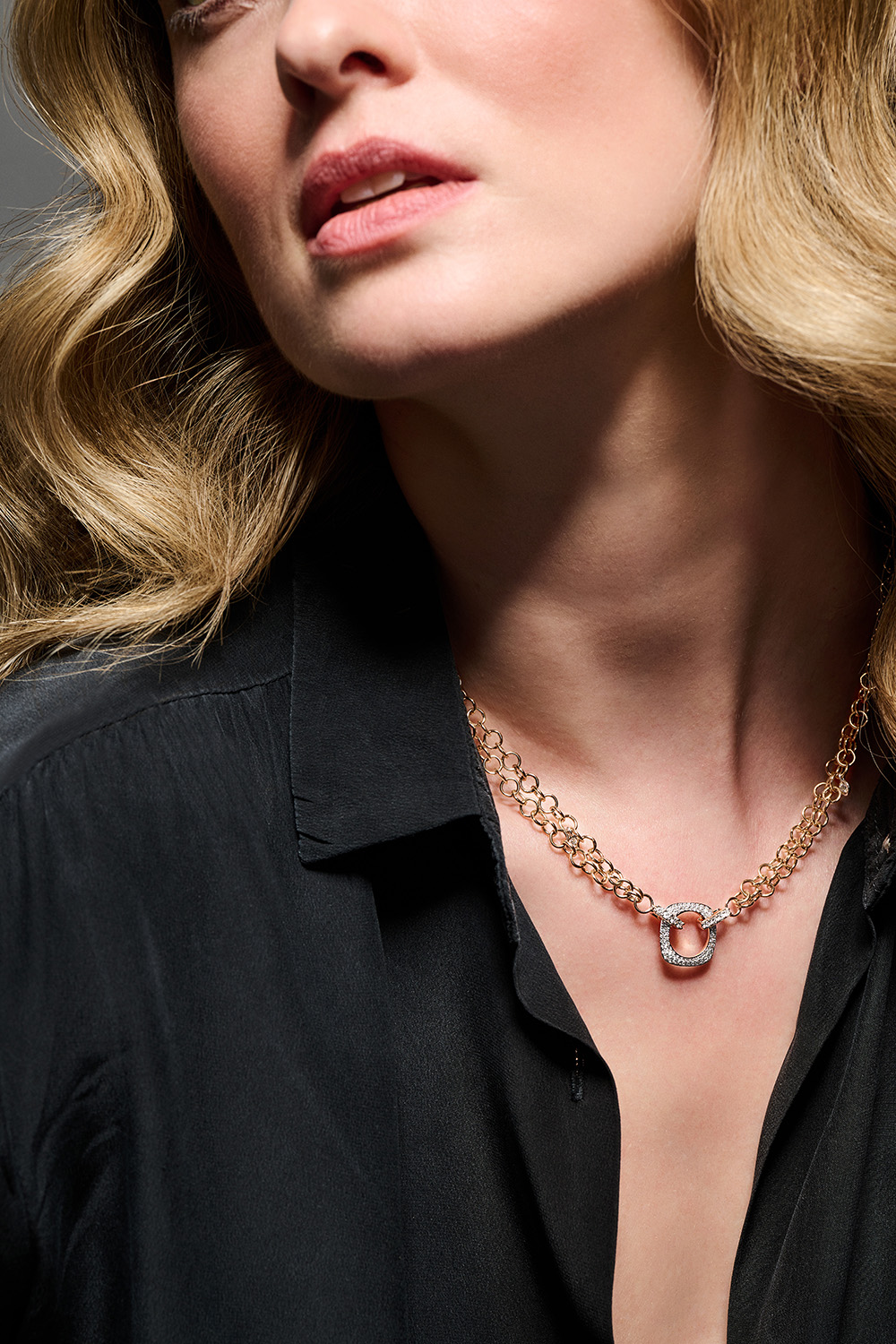 Elements necklace made with 18kt rose gold and white diamonds worn by a model